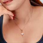 Close-up of a woman wearing a necklace with a heart pendant.