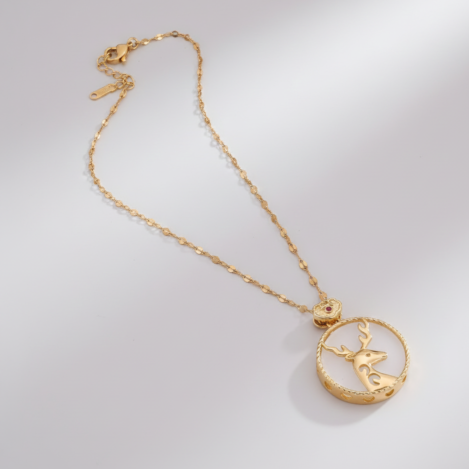 Gold necklace with a crescent moon and star pendant on a light gray background